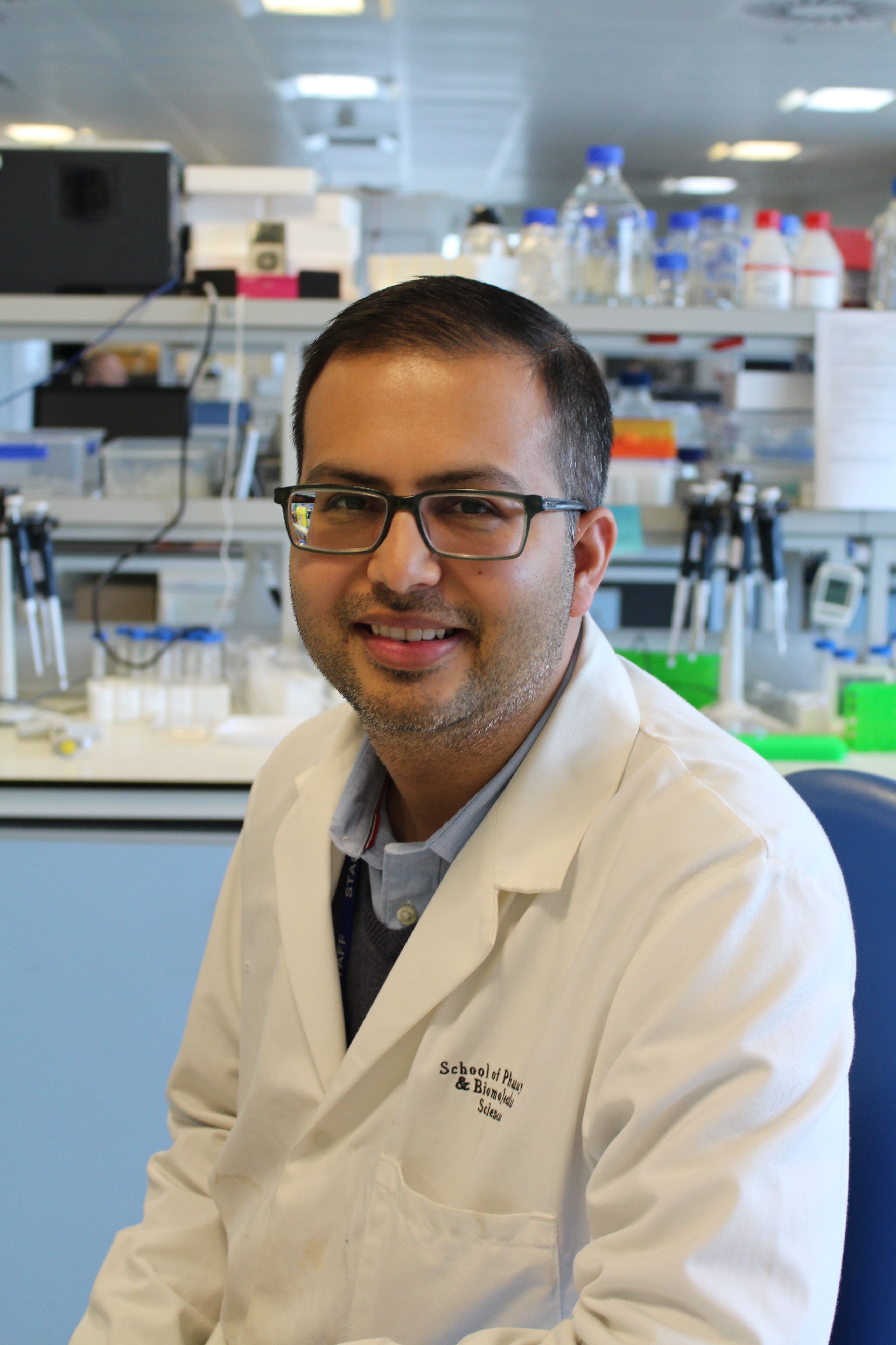 Professor Bhavik Patel in a white lab coat