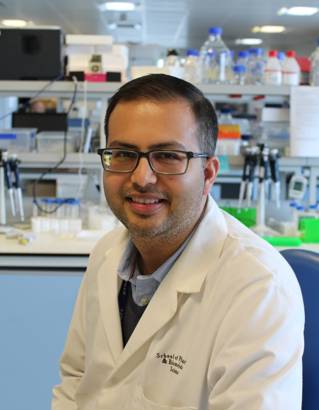Professor Bhavik Patel in a white lab coat