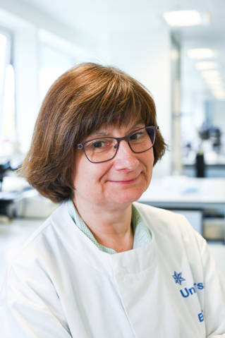 Dr Sarah Pitt in a white lab coat