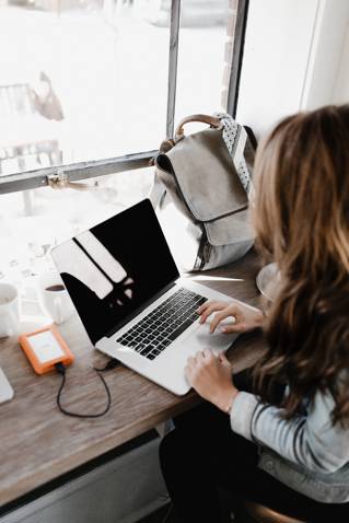 Student with laptop by Andrew Neel Unsplash