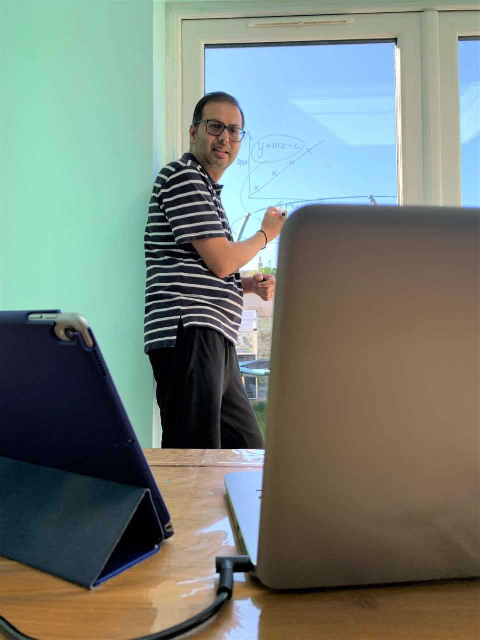 Bhavik with his window white board photo by his seven-year-old daughter Diva