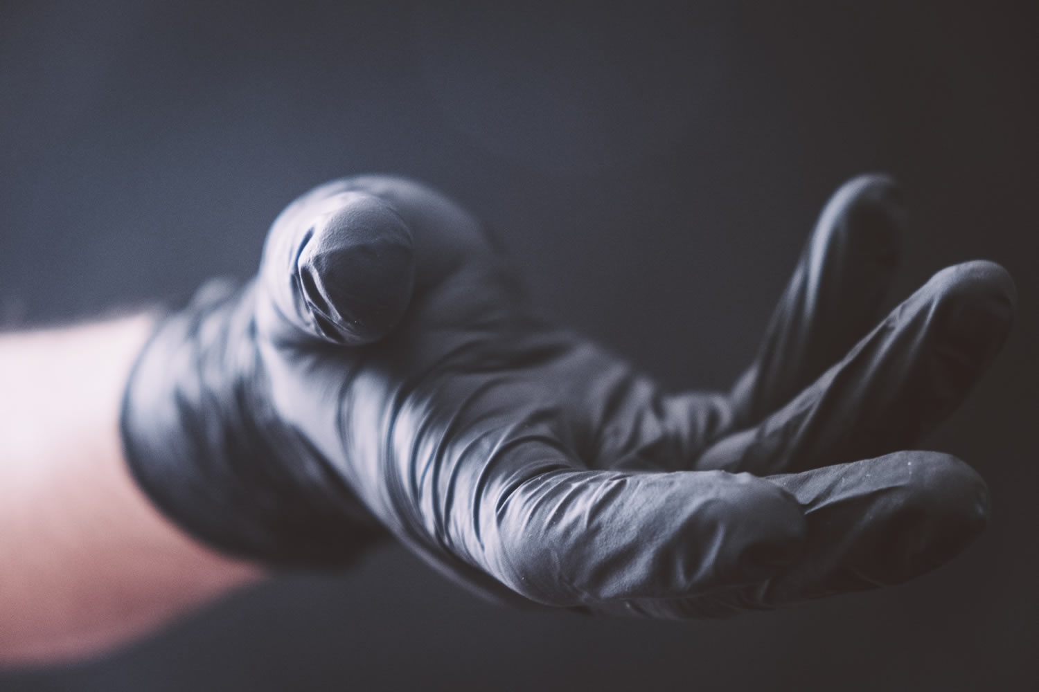 Gloved hand held out to give assistance Photo by Benedikt Geyer on Unsplash