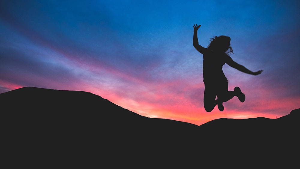 Happy girl jumping in the air by Austin Schmid