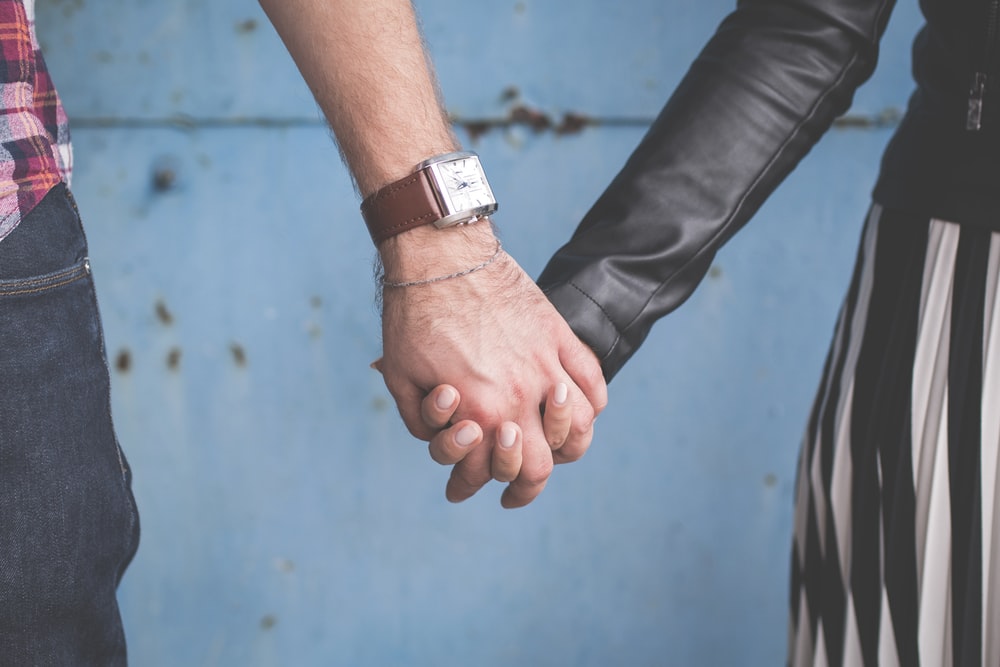 Image of two people holding hands