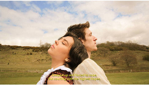 Two people standing back to back in a field