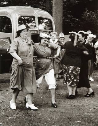 Black and white photograph of women dancing on grass in 1954