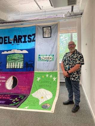 Harry Hillery with an AIDS Memorial quilt
