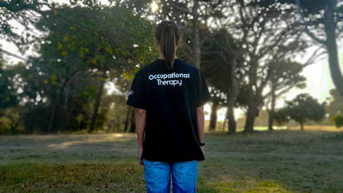 Lady with black shirt with words occupational therapy by Meelan Bawjee via Unsplash