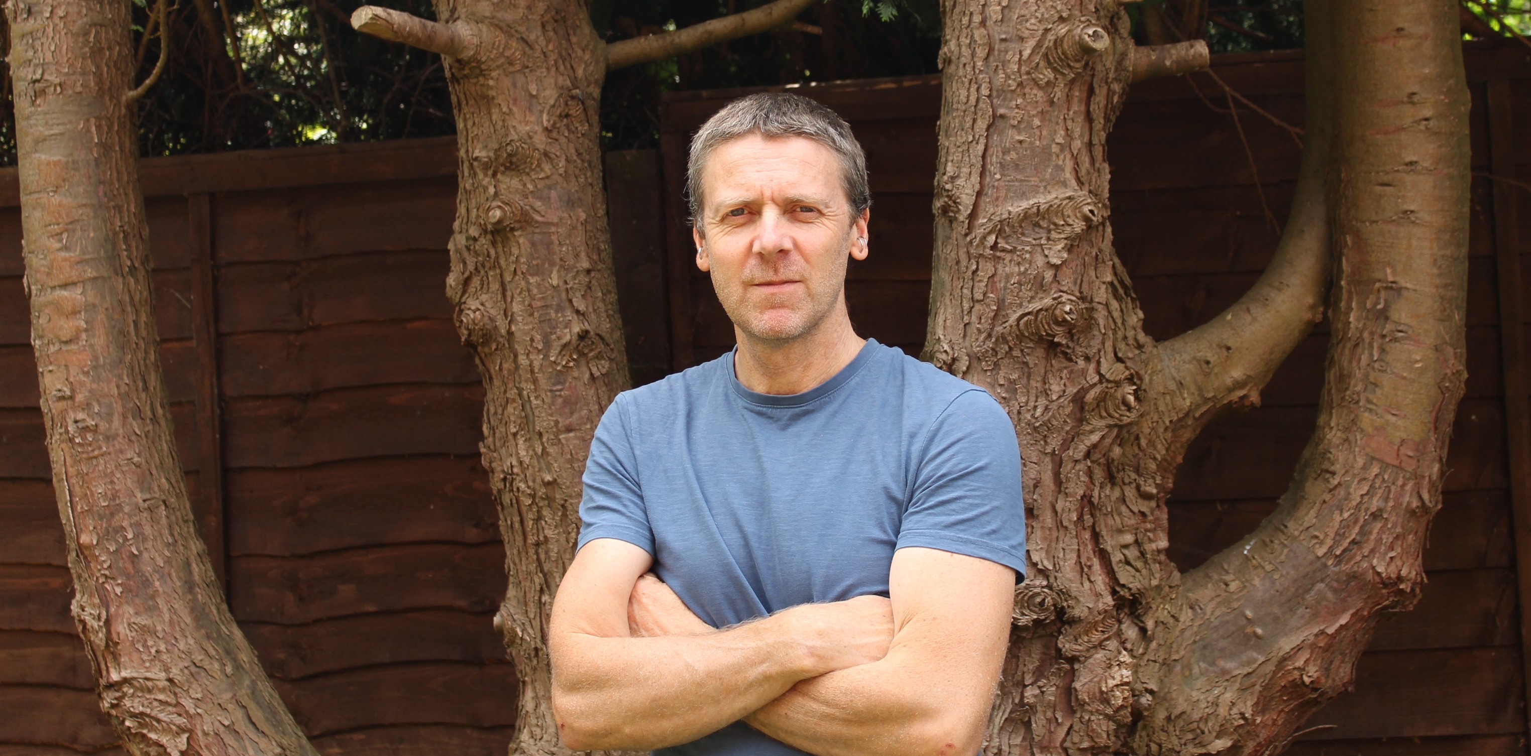 Dr Marcus Dymond in front of a large tree