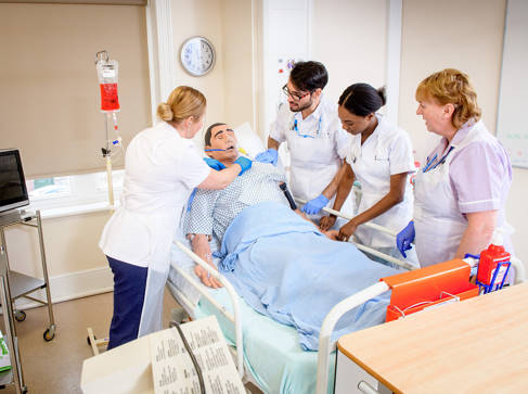 Medical students with hi-tech mannequins