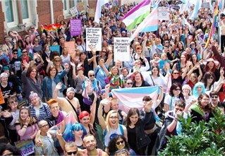 Trans Pride parade crowd with banners