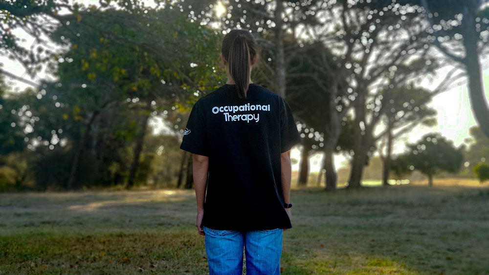 Lady with black shirt with word occupational therapy by Meelan Bawjee via Unsplash