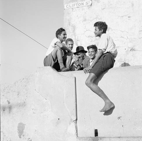 Black and white photograph of boys on a house roof from the Other lives of the image collection