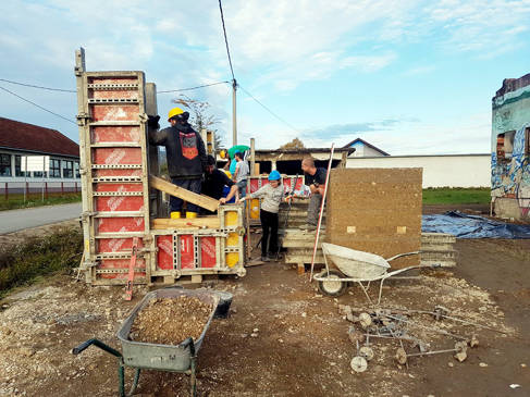 Architecture students building rammed earth prototypes