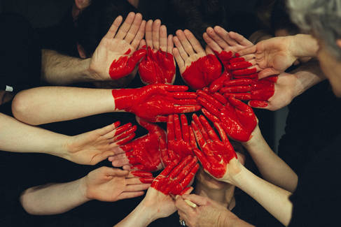 Hands covered in red liquid making a heart by Tim Marshall, Unsplash