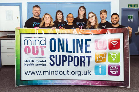 MindOut staff with banner