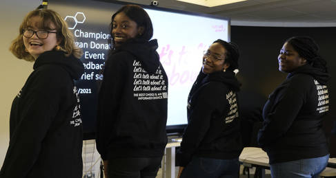 Five students wearing hoodies promoting their organ donation campaign
