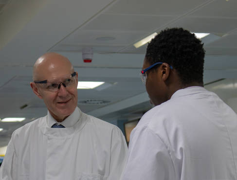 David Webb and a student, both in white coats and protective glasses