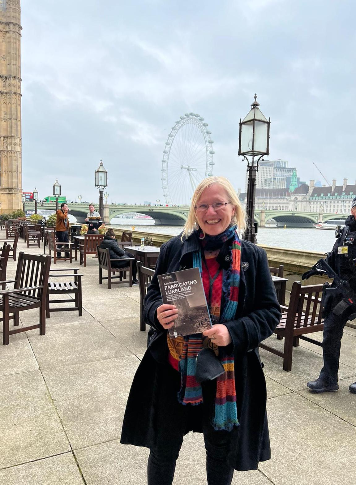 Dr Julia Winckler holding a book