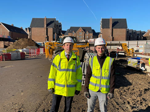 Two men in hi-viz on a building site
