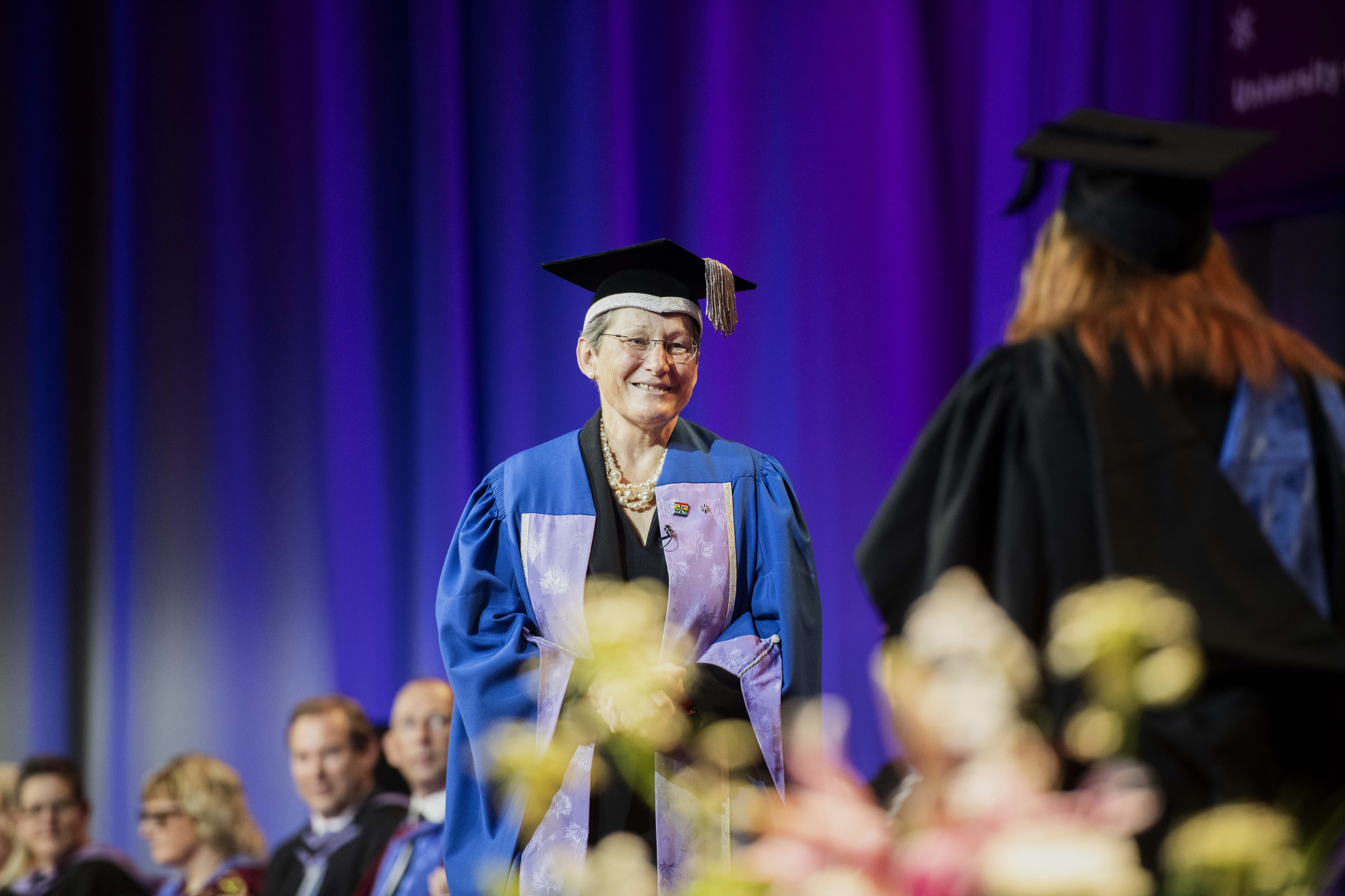Professor Debra Humphris CBE on stage at graduation