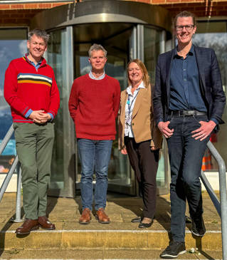 Four people standing on some stairs