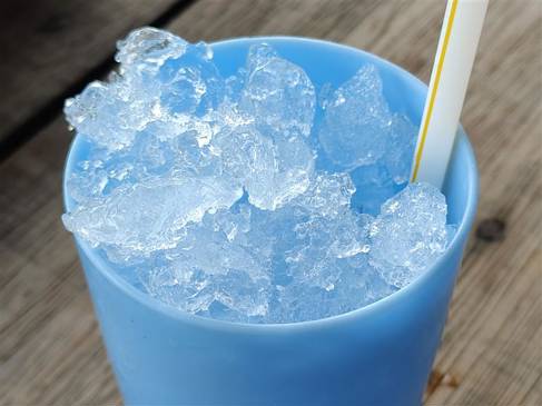 A blue plastic cup with ice in