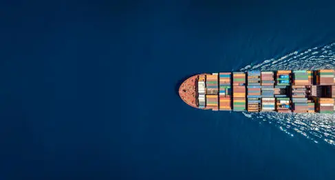 An aerial shot of a cargo ship at sea