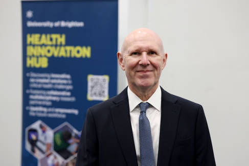 David Webb beside Health Innovation Hub banner