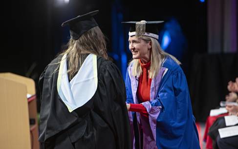 Donna Whitehead on stage with graduate