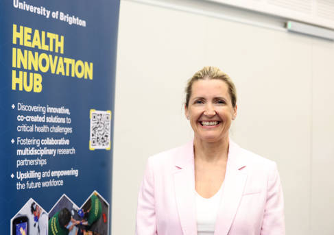 Professor Donna Whitehead beside a Health Innovation Hub banner