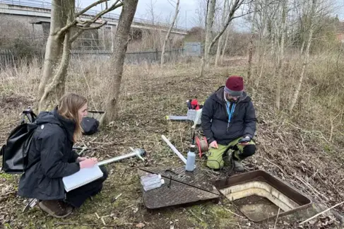Professor Martin Smith and Polly Walters collecting water samples