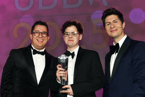 Isaac poses with plaque