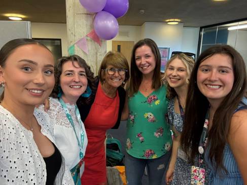 Student midwives pose for a selfie, all dressed in summer clothes