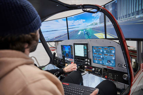 Two students using aerospace engineering simulation equipment 