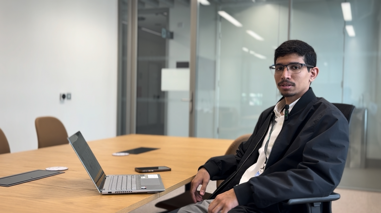 Abdulmalik behind computer