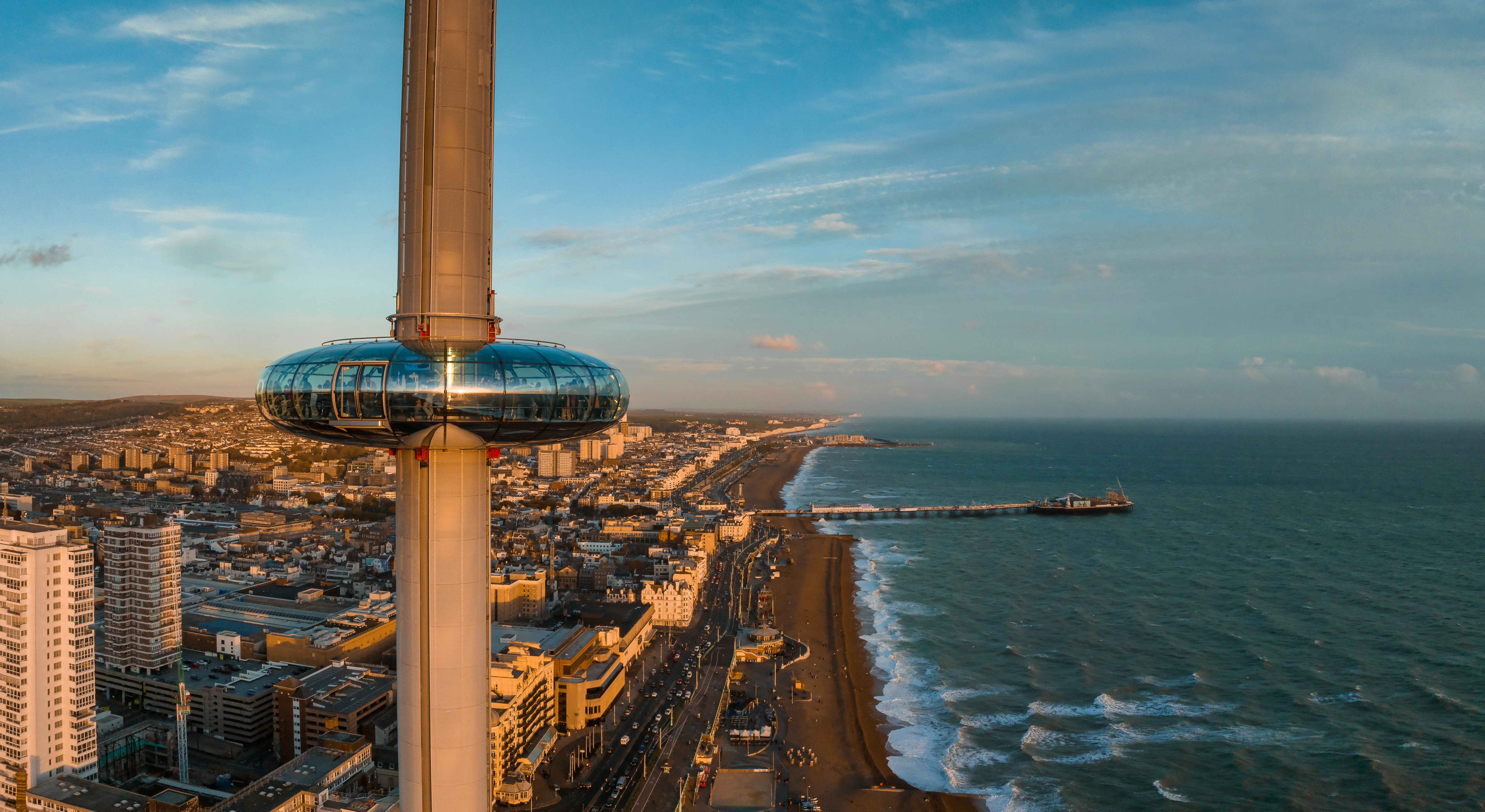 Drone shot of Brighton's i360 on a sunny day with the city and sea in the background