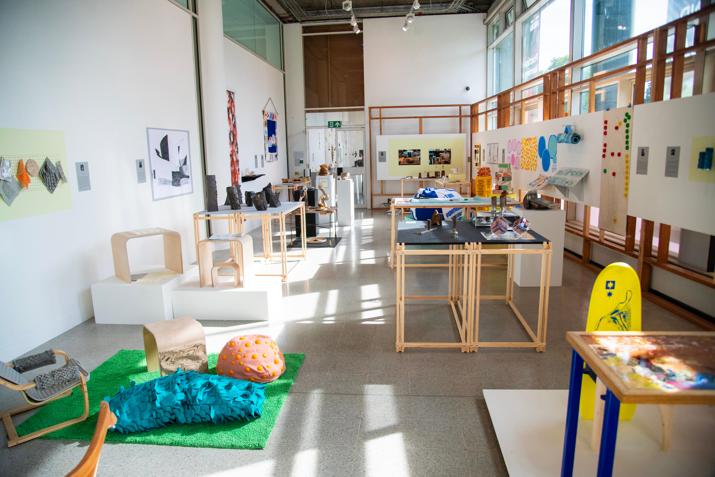 Show room full of 3D & design work, with dappled lighting