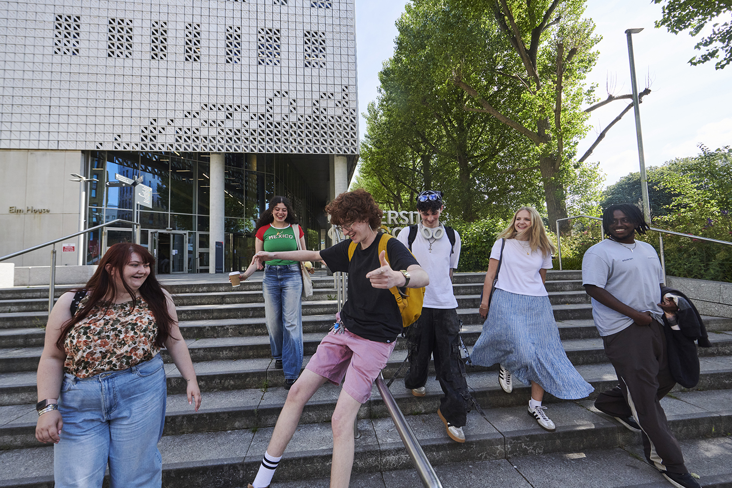 Student sliding down stairs exterior Elm House