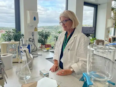 A female Marine biologist in a lab coat, in a science lab