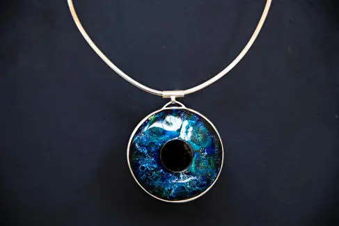A silver necklace with an eye pendant