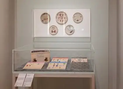 Art on display in an art gallery, in a cabinet and on the walls