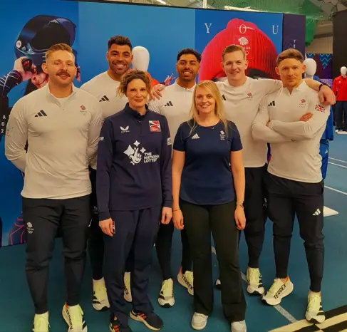 Physiotherapist Katy Williams has her picture taken with male members of Team GB Bobsleigh and Skeleton 