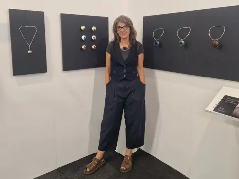 Rebecca Cormack poses next to her work