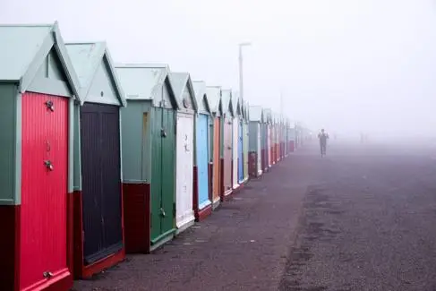 Runners jog along Bighton seafront in the mist