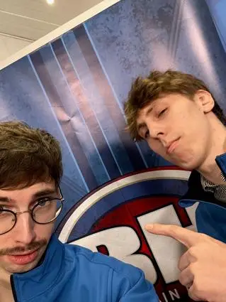 Two boys in blue jumpers take a selfie