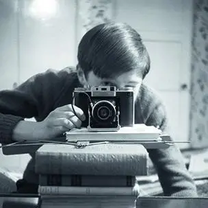 Self portrait of young Robert Cooper with camera