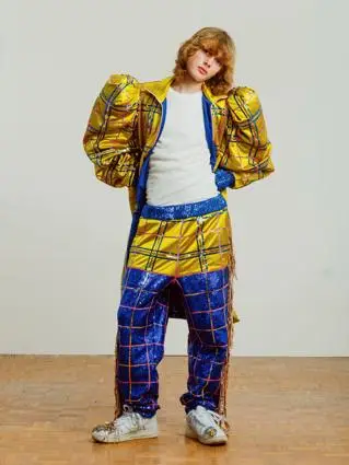 Young man poses in sparkly outfit
