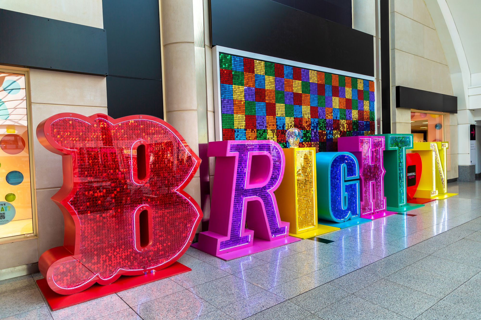 A large Brighton sign in rainbow colours