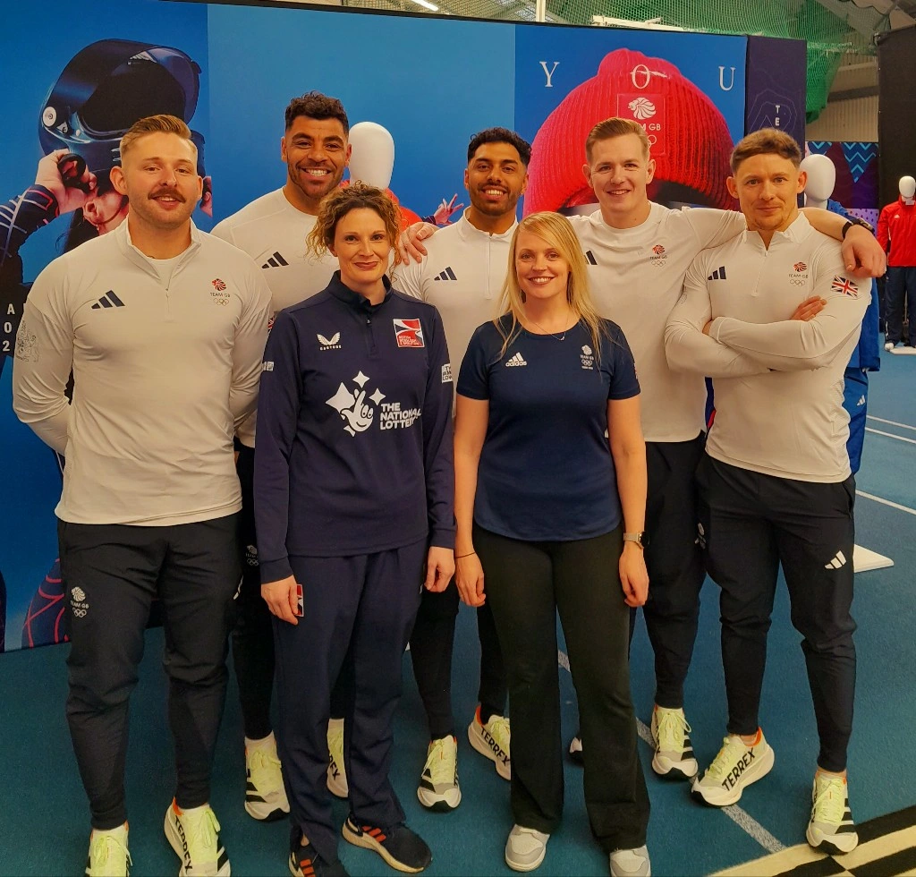 Pyshiotherapst Katy Williams has her picture taken with male members of Team GB Bobsleigh and Skeleton
